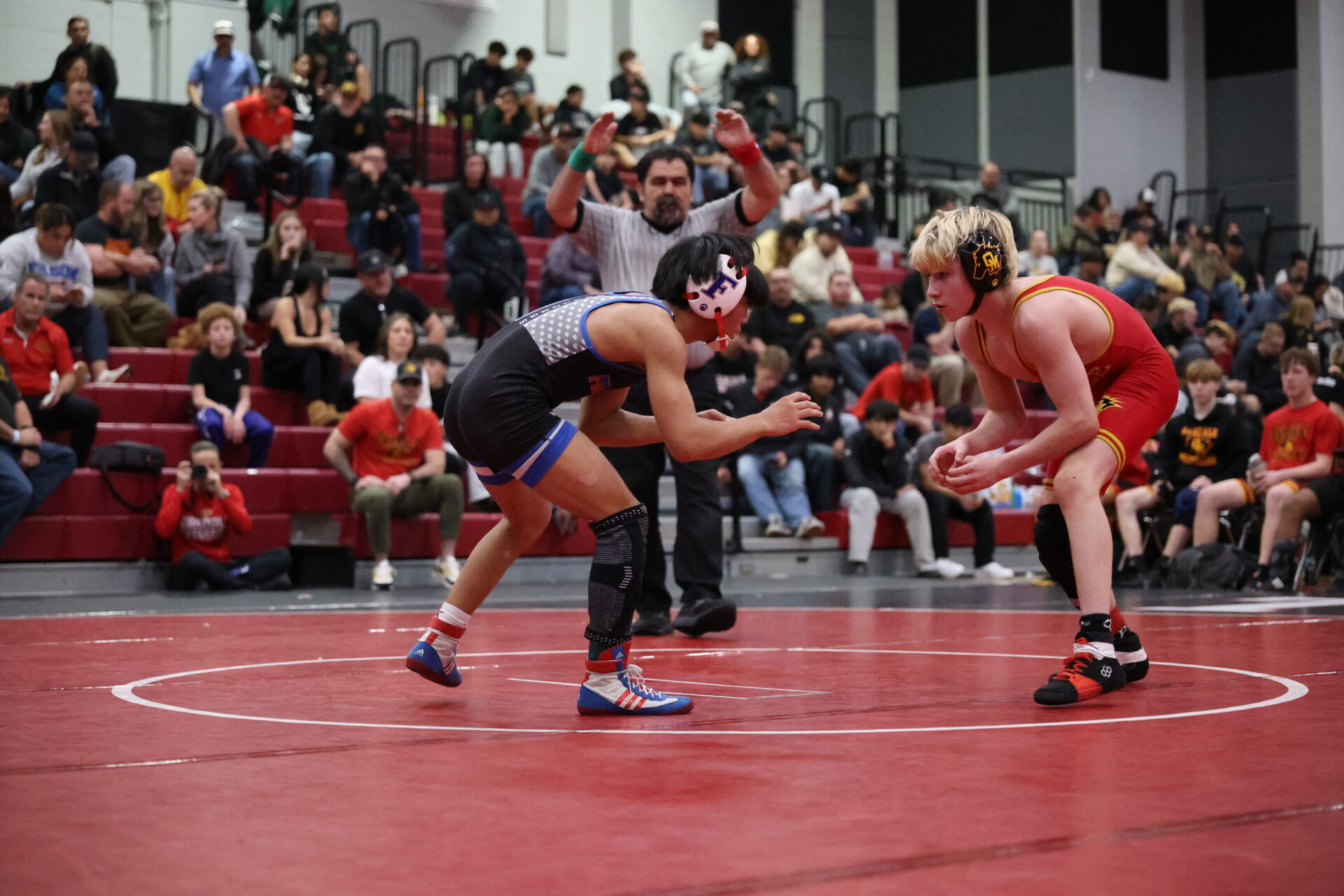 Folsom wrestler facing an opponent on the competition mat